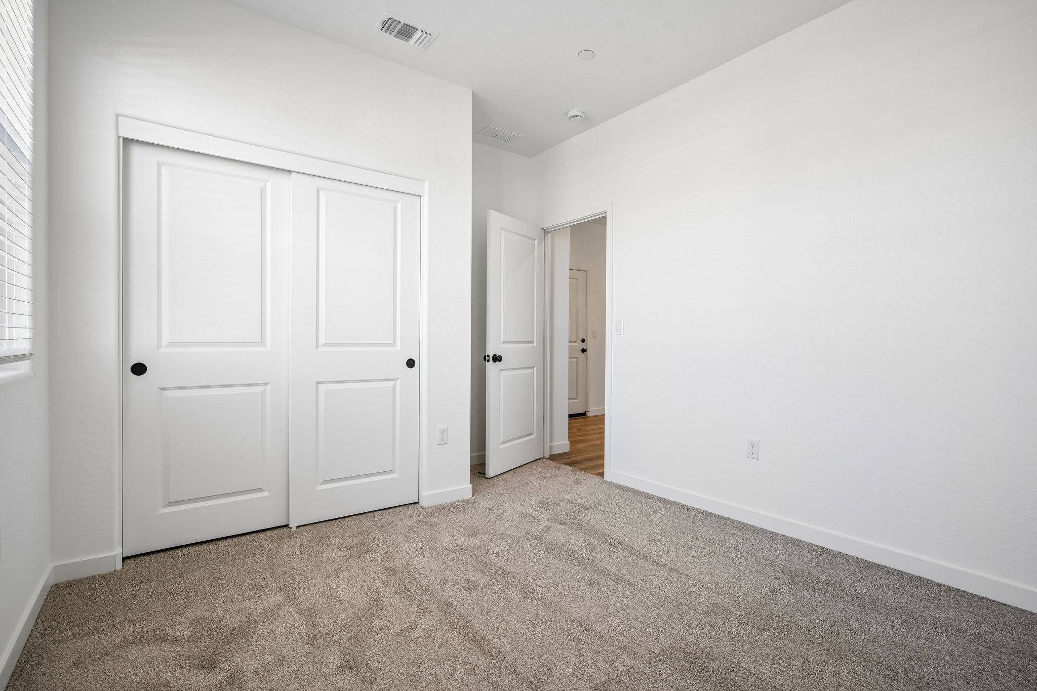 A hallway with white doors.