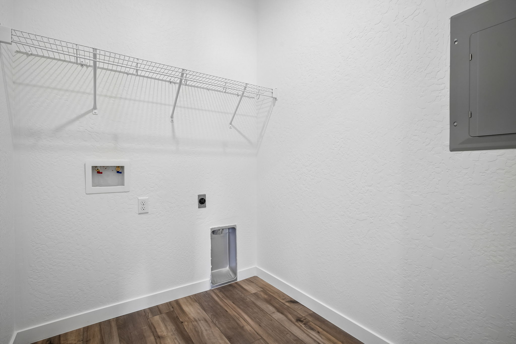 A room with a wood floor and a metal railing.