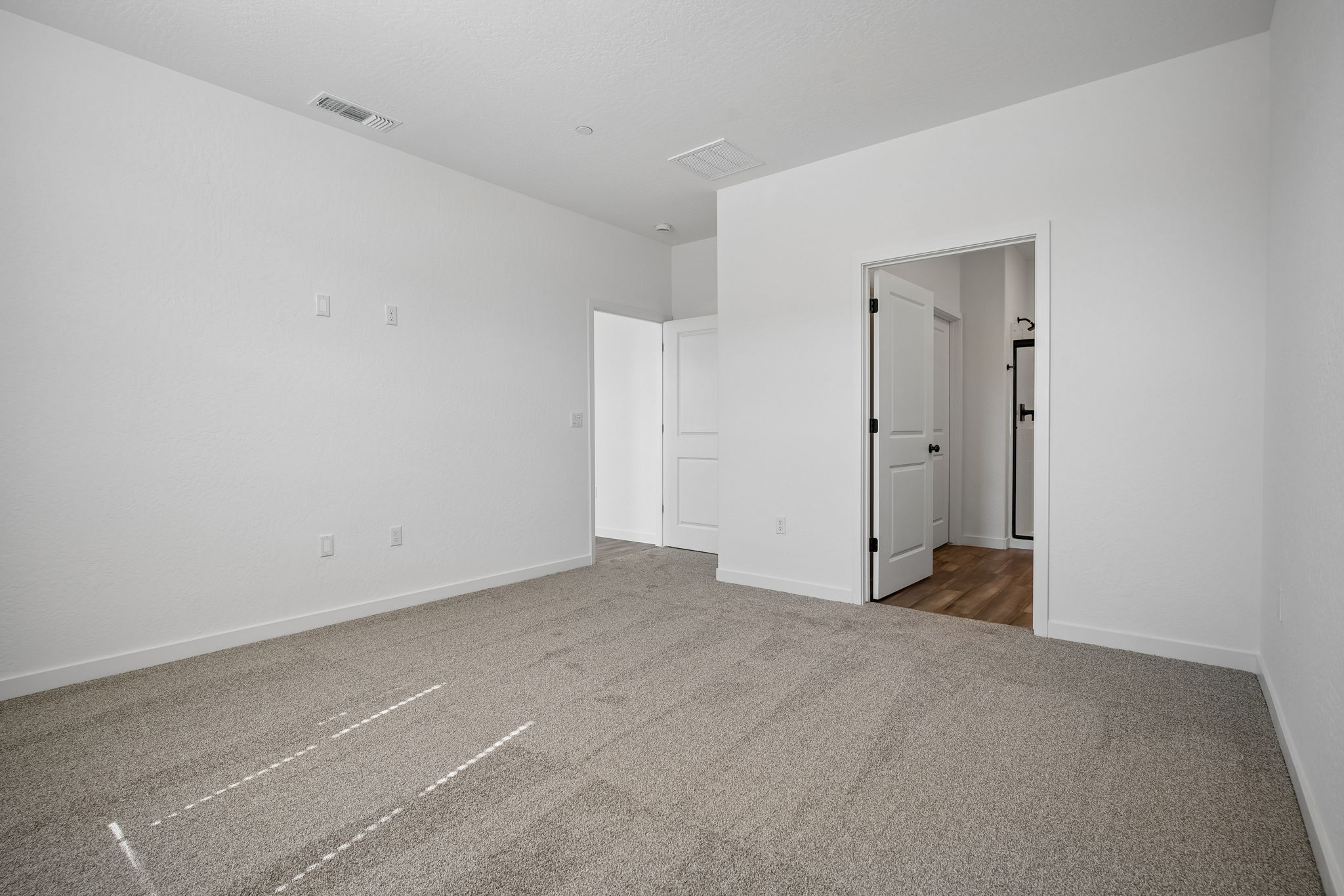 A hallway with white walls.