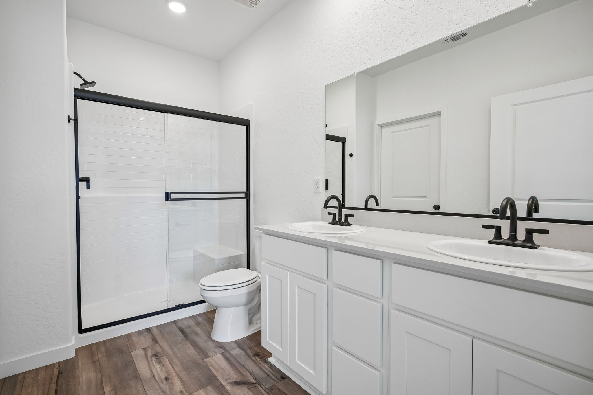 A bathroom with a sink toilet and shower.