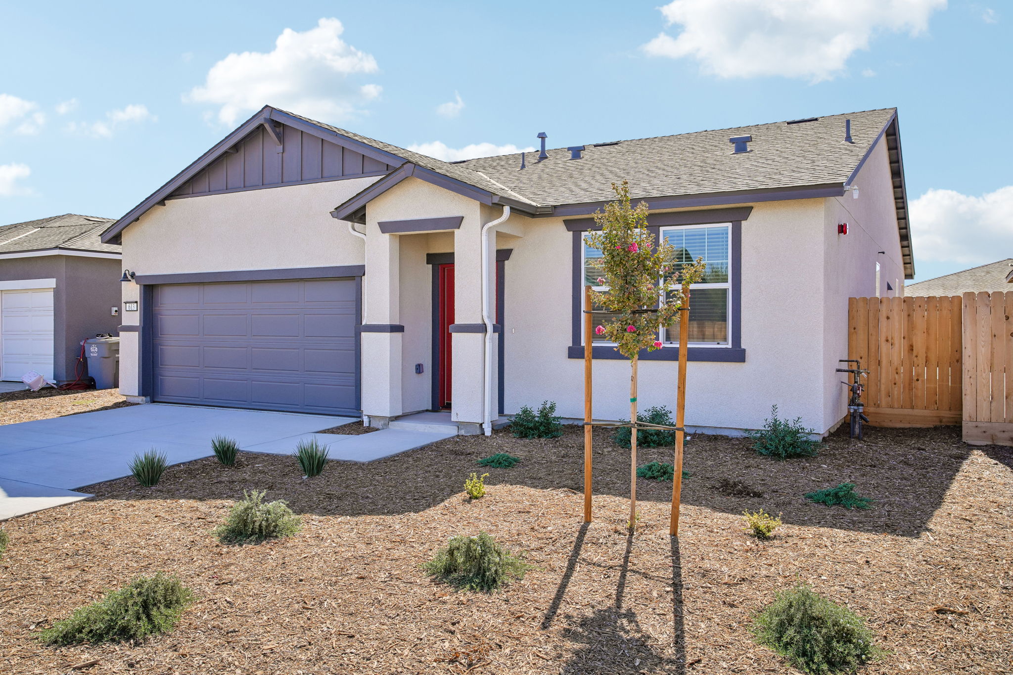 A house with a tree in the front yard.