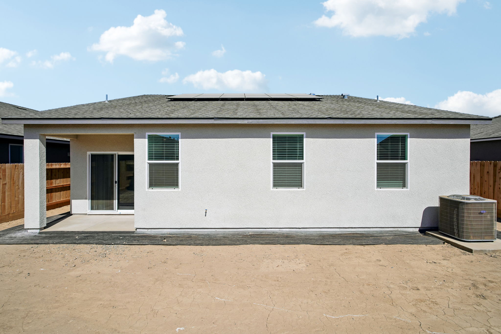 A white house with a black roof.