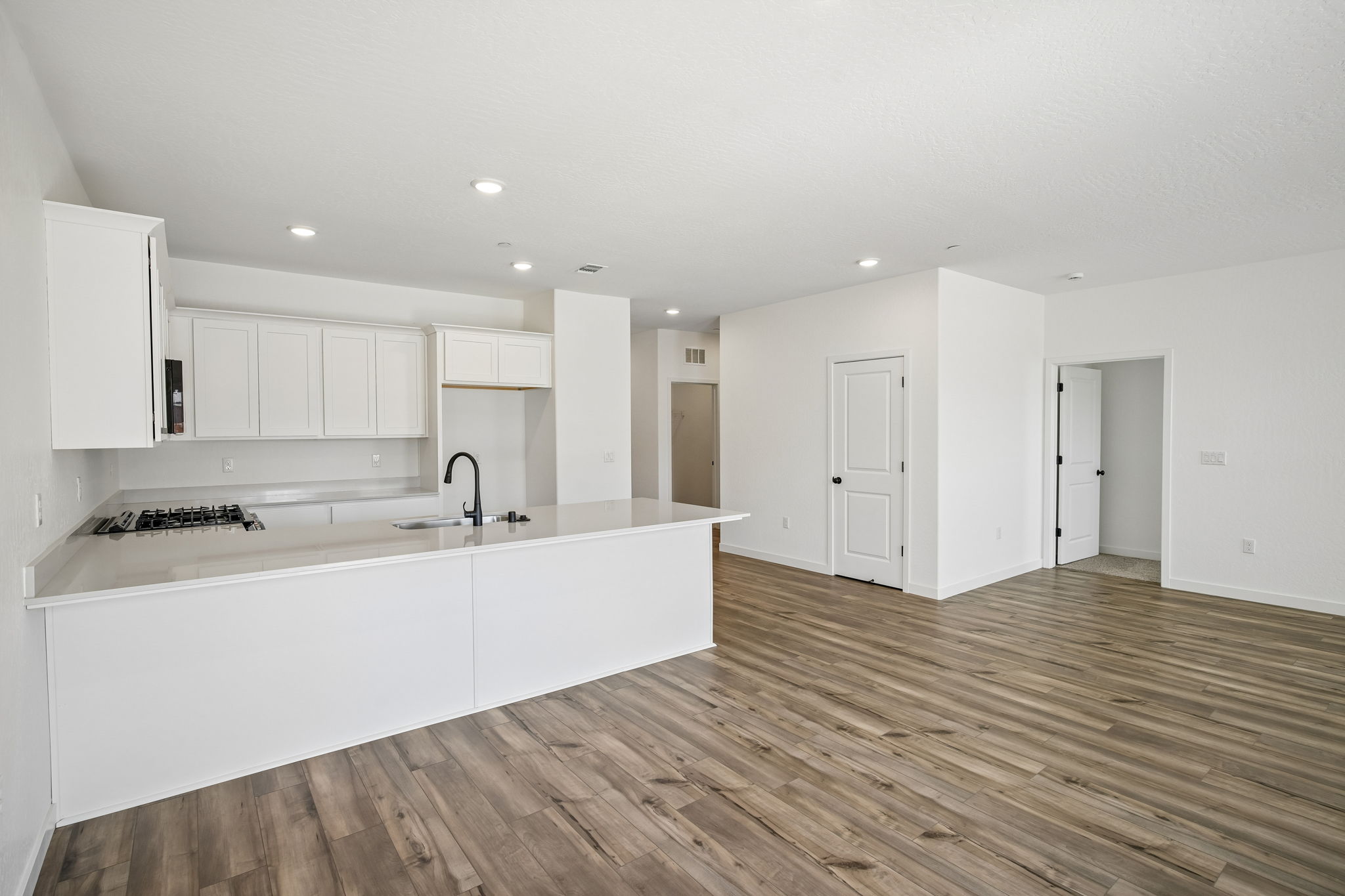 A kitchen with white cabinets.