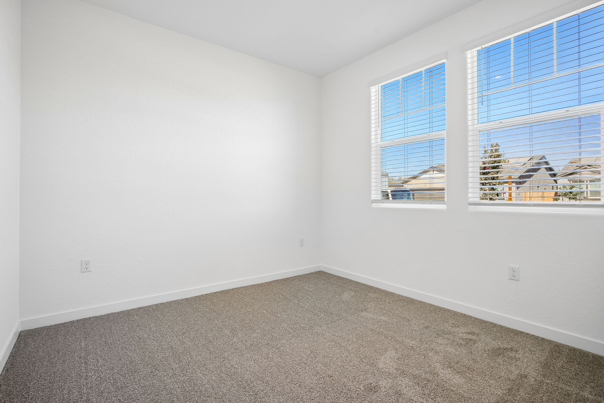 A room with a window and a carpet.