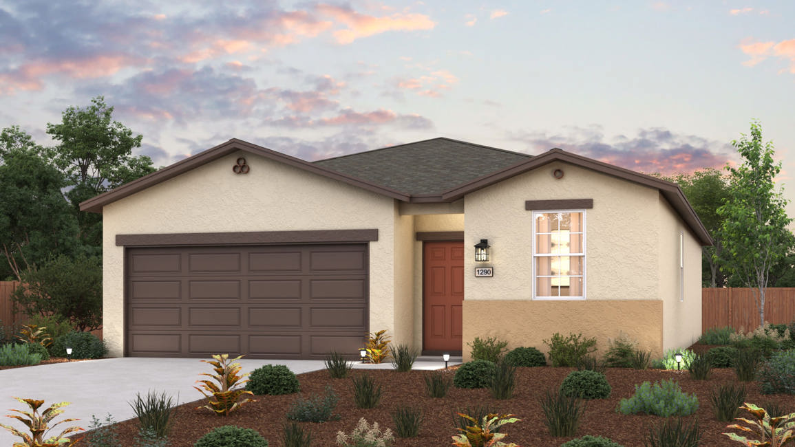 A house with a garage and bushes in front of it.