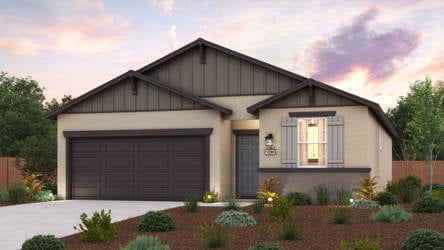 A house with a garage and bushes.