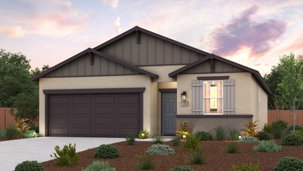 A house with a garage and bushes.
