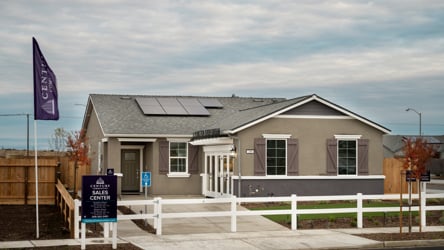 A house with a sign in front.