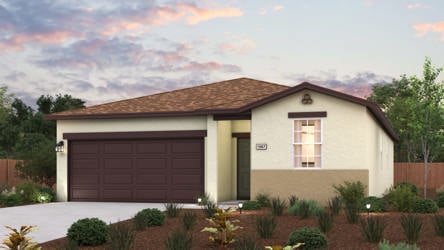 A house with a garage and bushes.