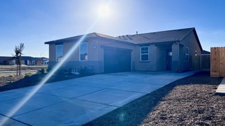 A swimming pool in front of a house.