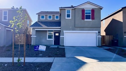 A house with garages and a fence.