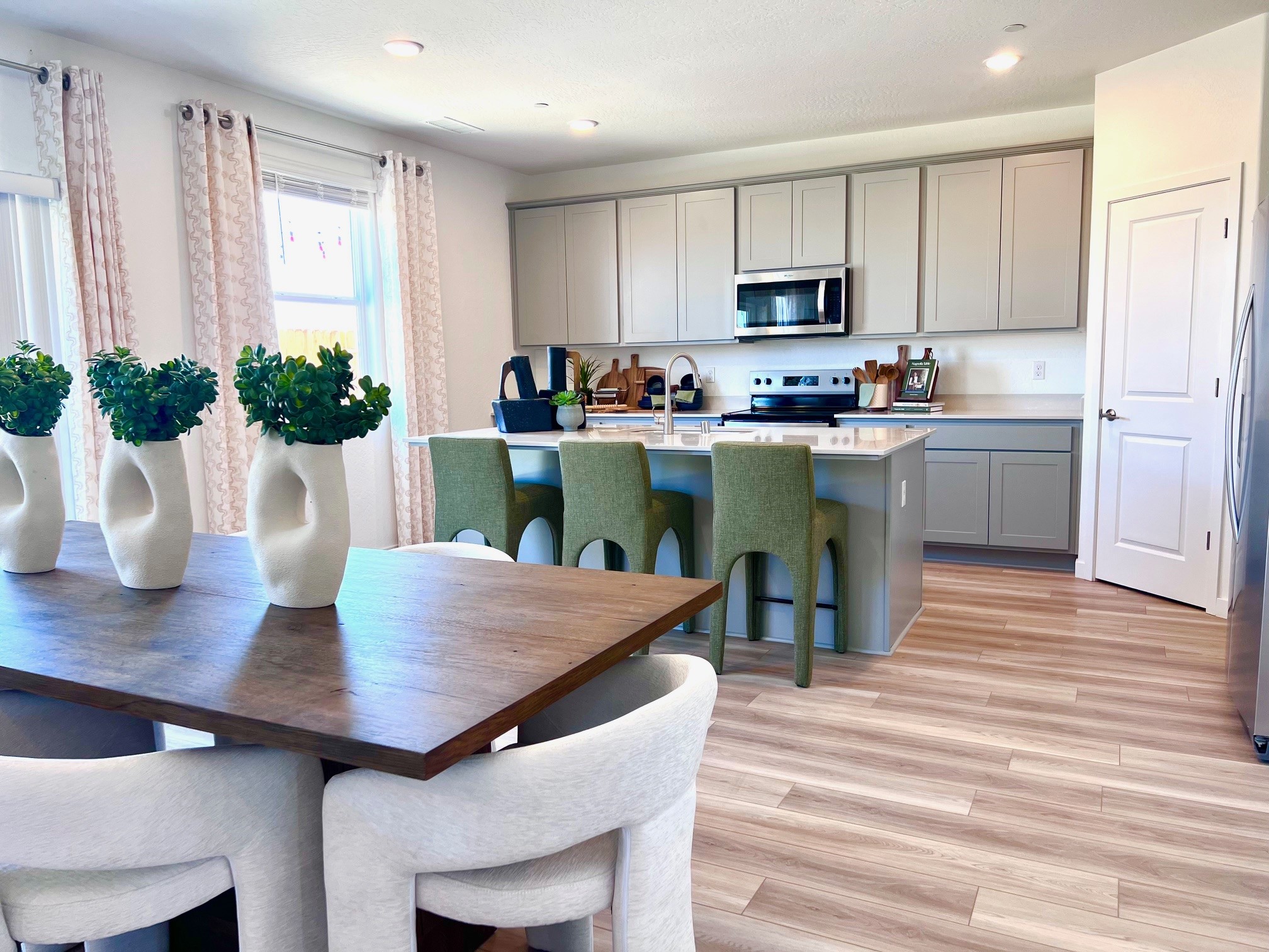 A kitchen with a table and chairs.