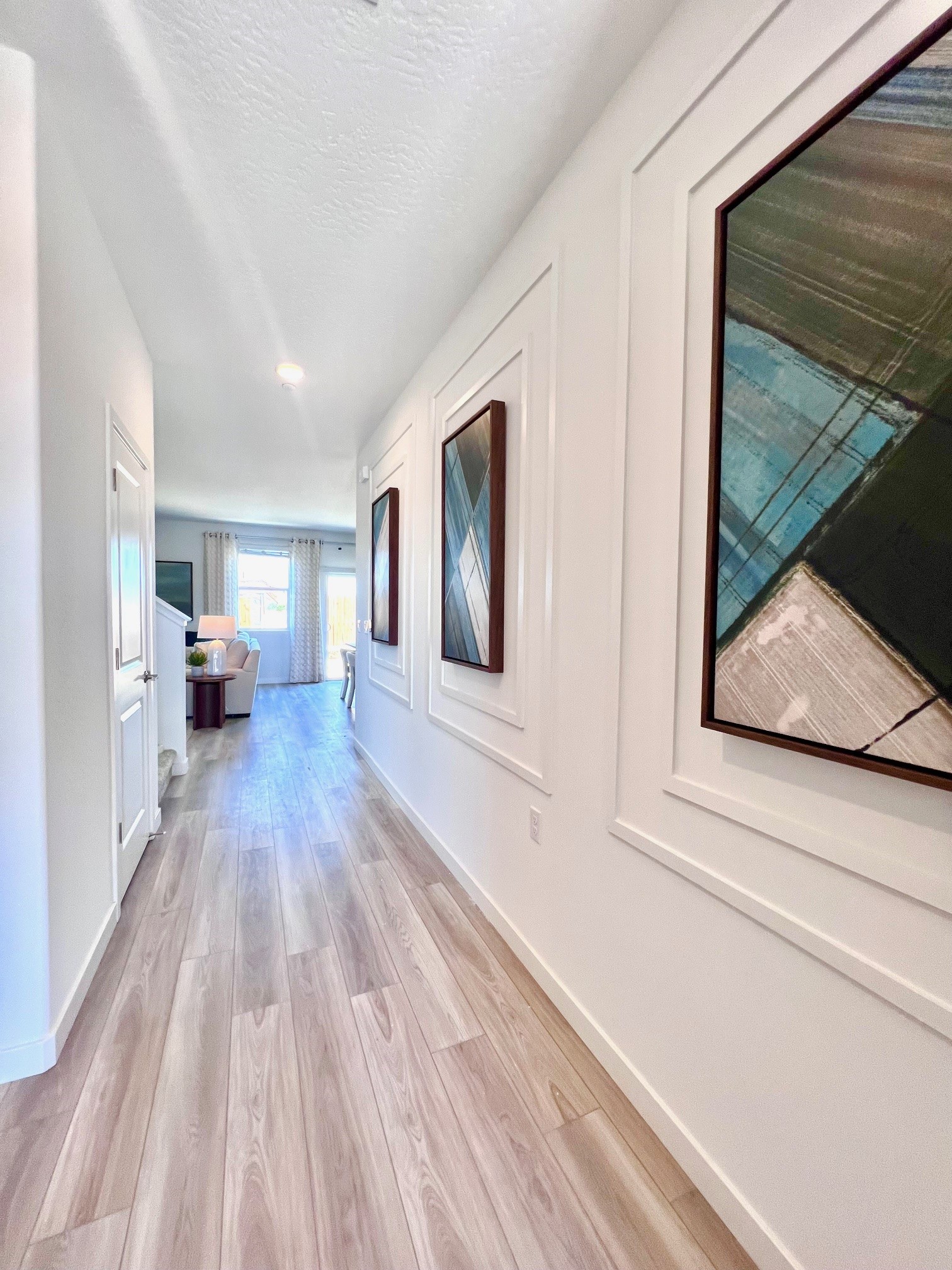 A hallway with a wood floor.