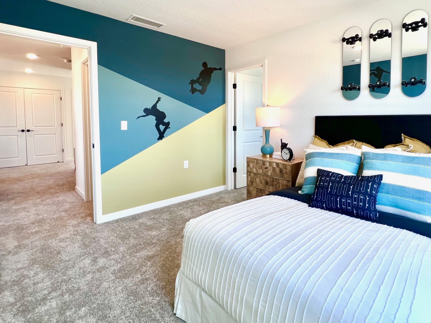 A bedroom with a bed and a lamp.