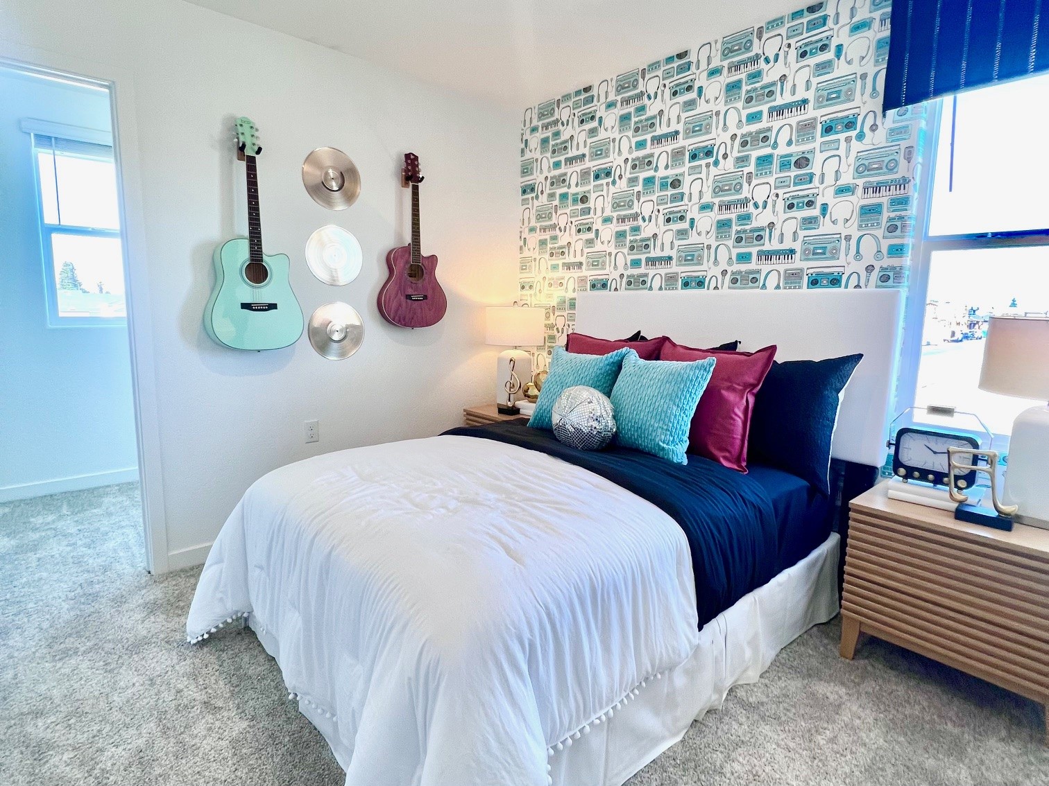 A bedroom with a bed and guitars.