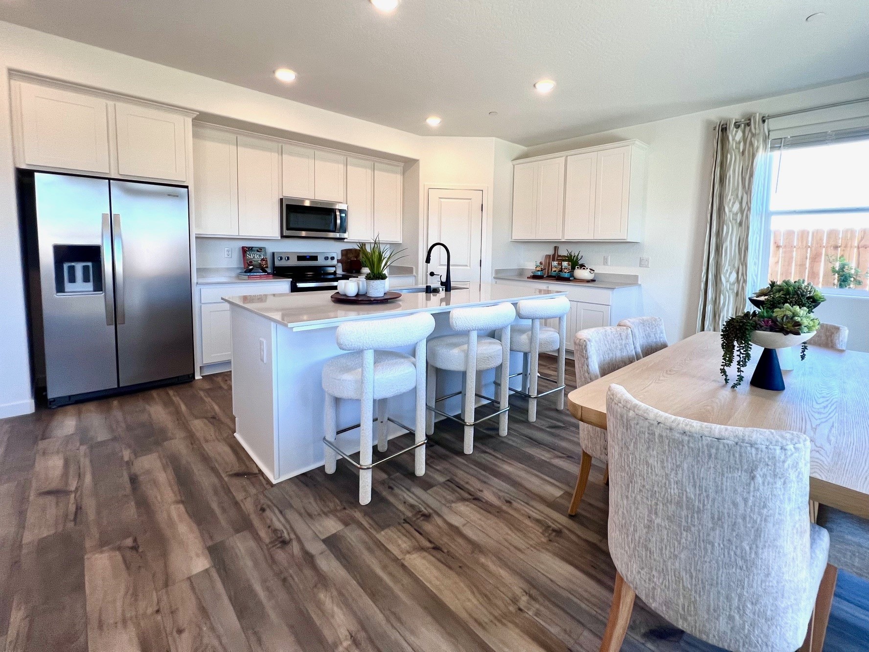 A kitchen with a table and chairs.