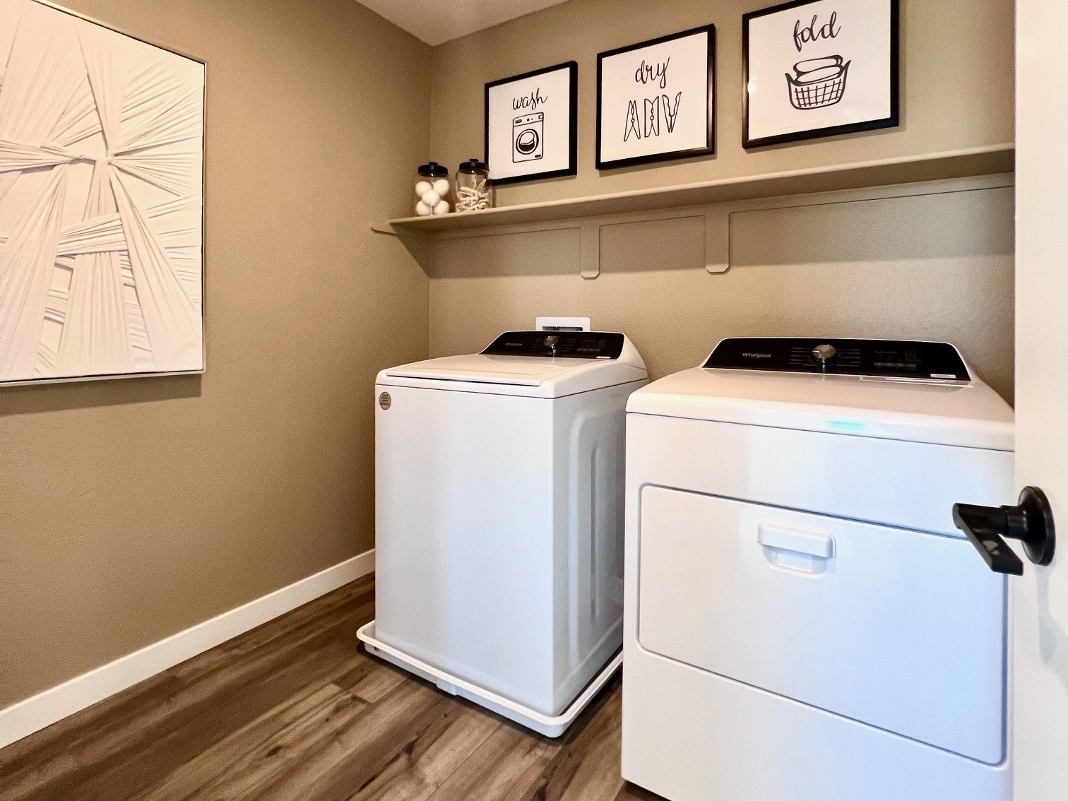 A kitchen with a washer and dryer.