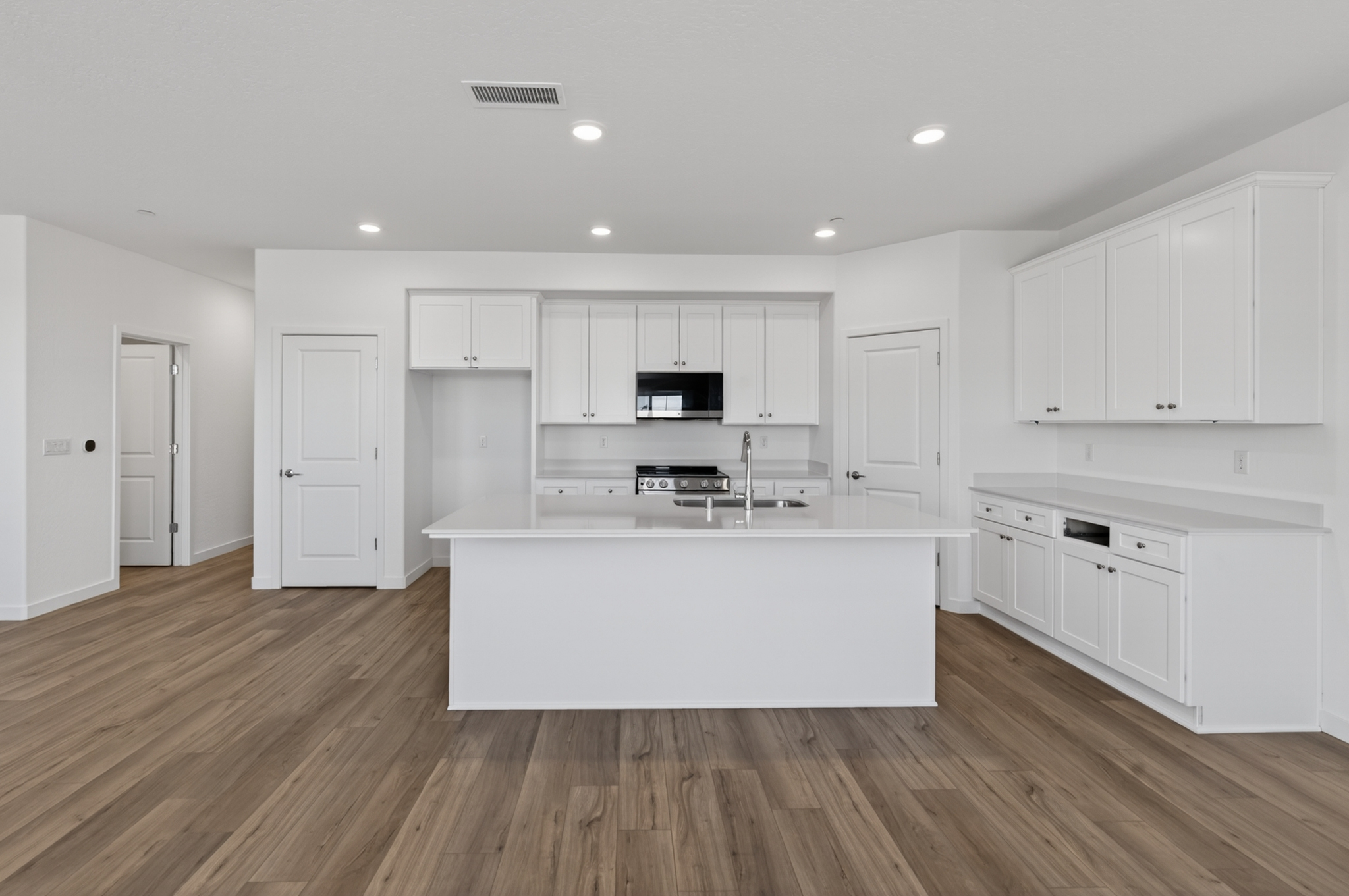 A kitchen with white cabinets.