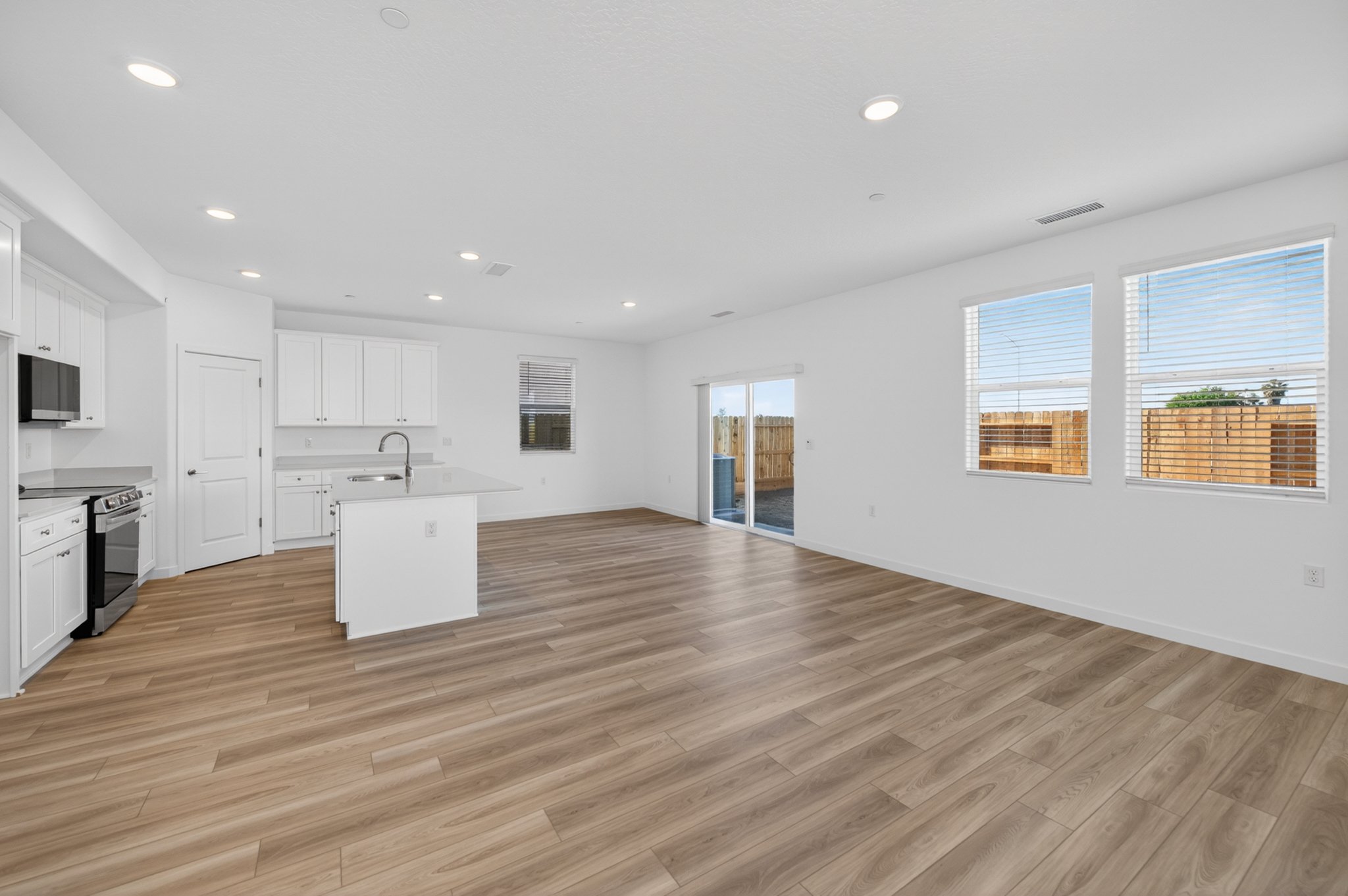 A large kitchen with white cabinets.