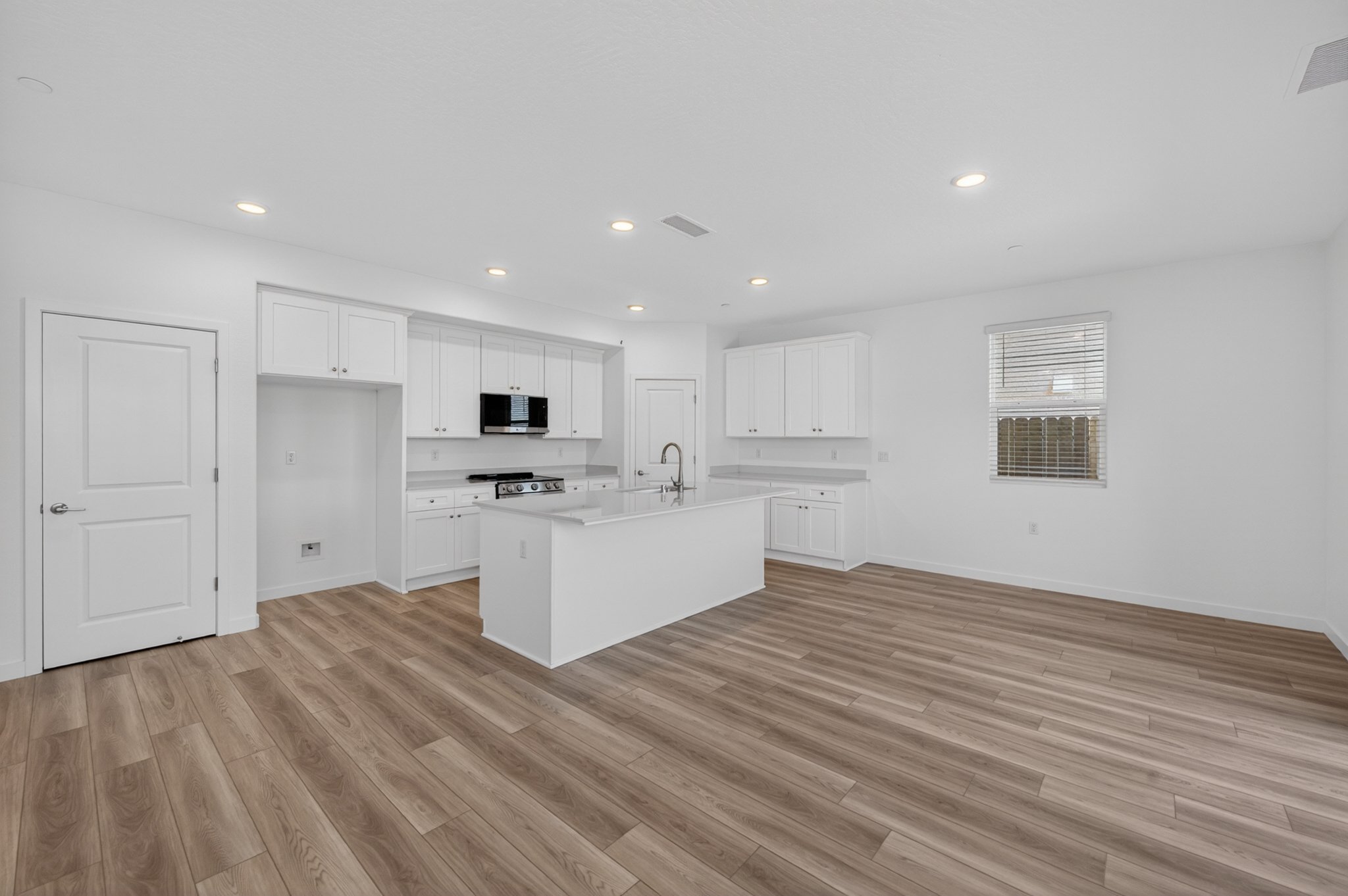 A kitchen with white cabinets.