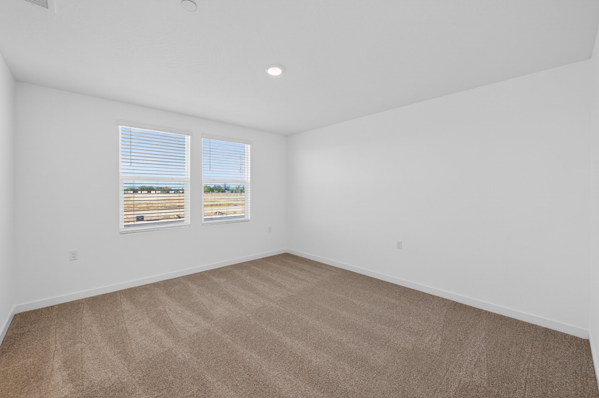 A room with a carpet and a rug.
