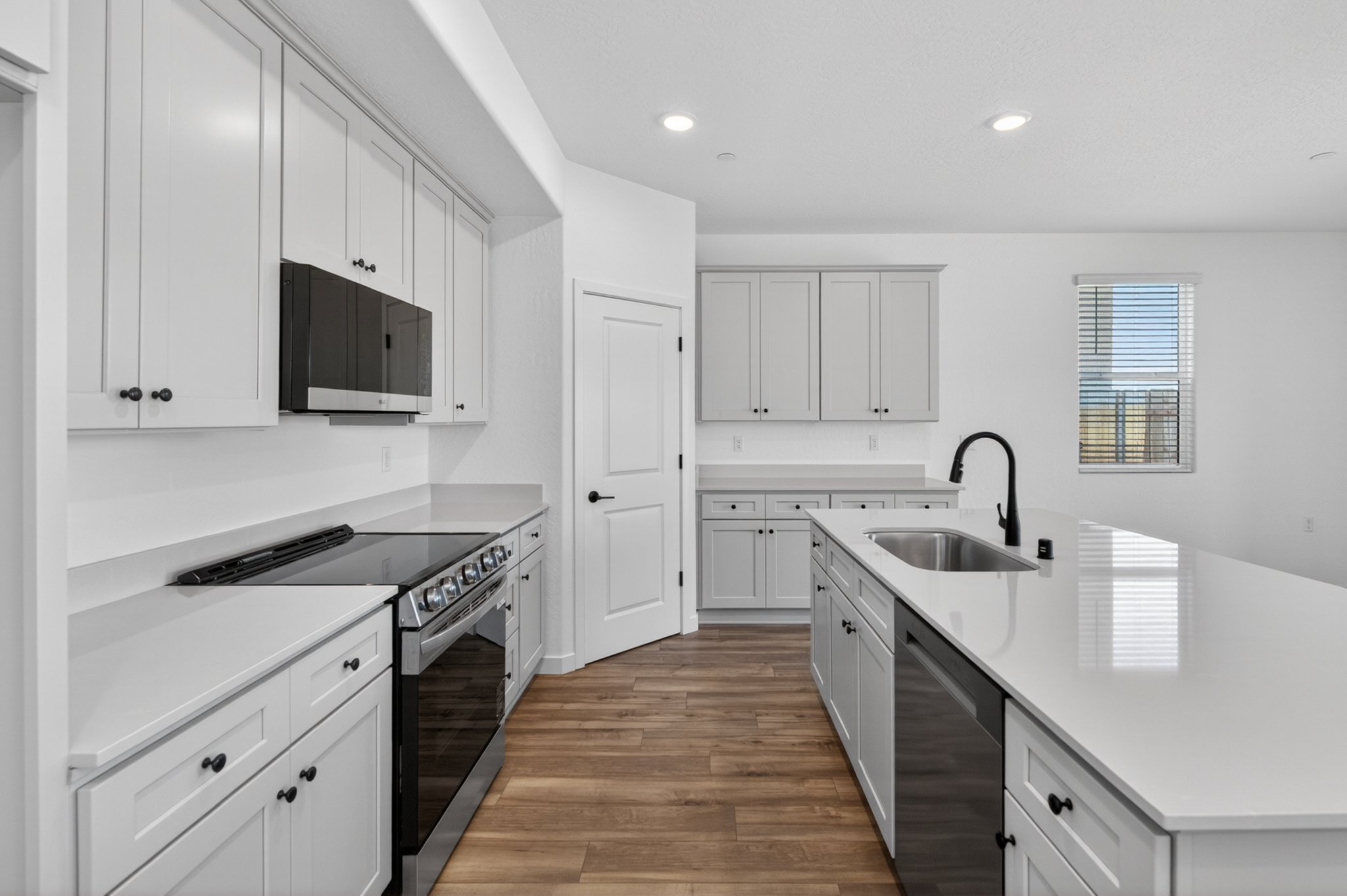 A kitchen with white cabinets.