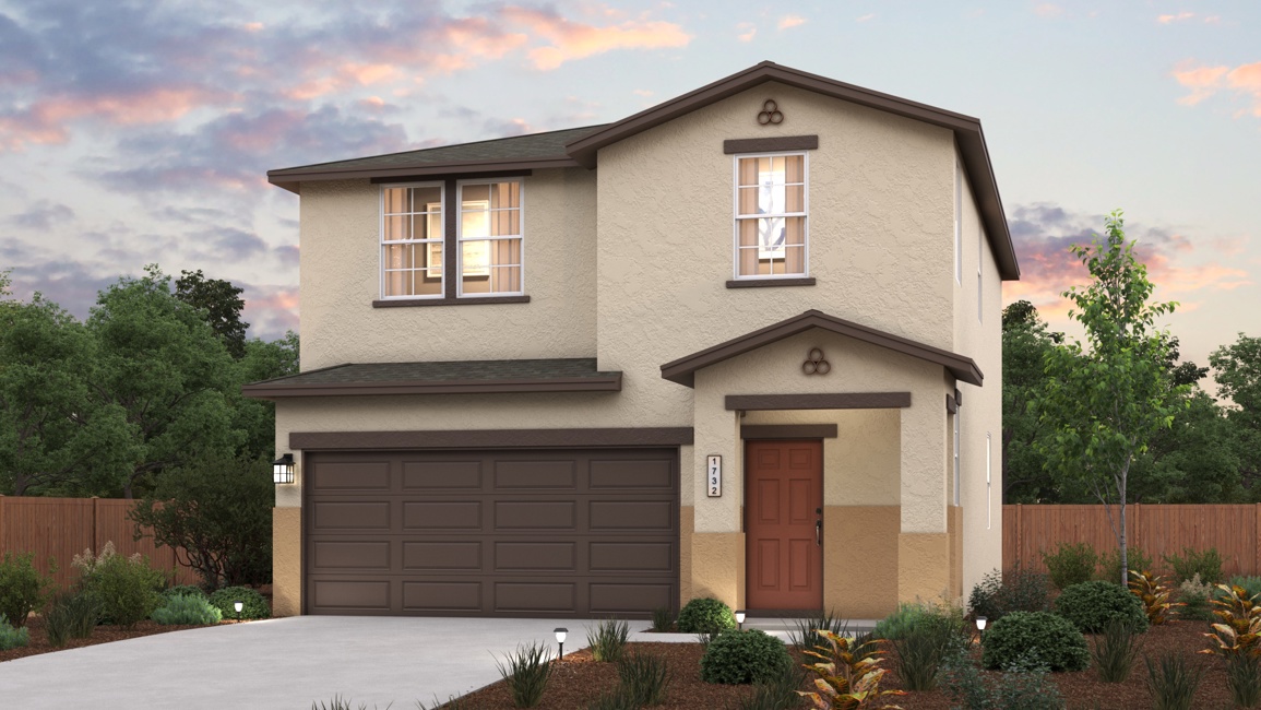 A house with a garage and trees in the back.