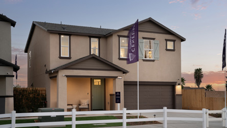 A house with a white picket fence.