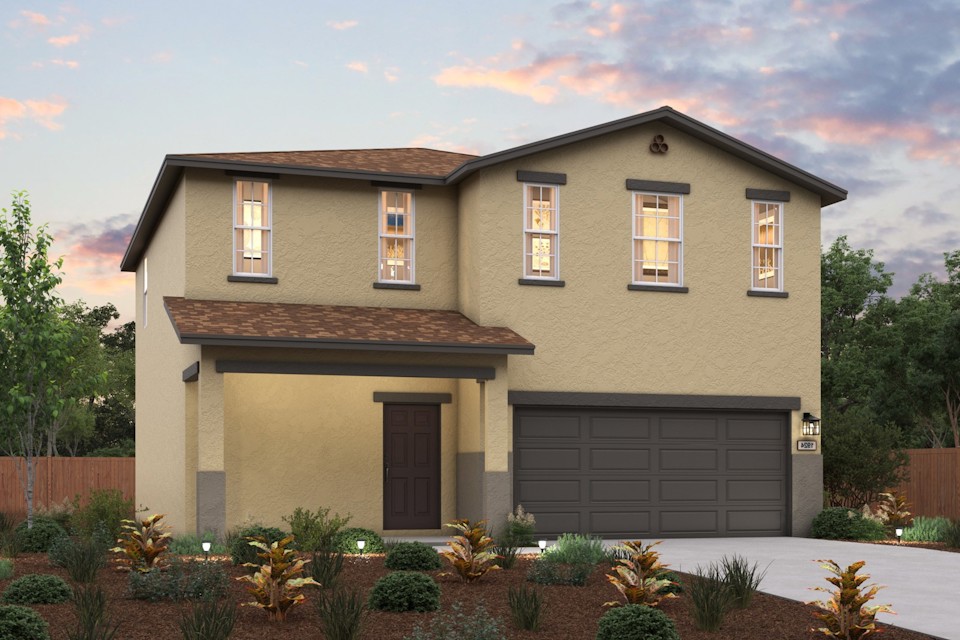 A house with a garage and bushes in front of it.