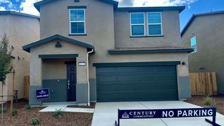A building with garages and a sign in front of it.