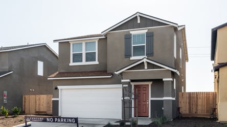 A house with garages and a fence.