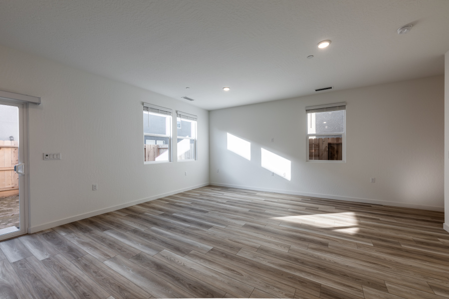 A room with a wood floor and windows.