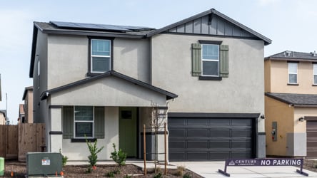 A grey house with a garage.
