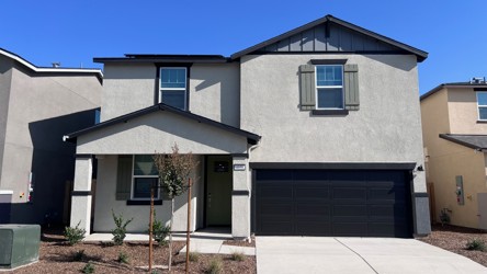 A grey house with a garage.