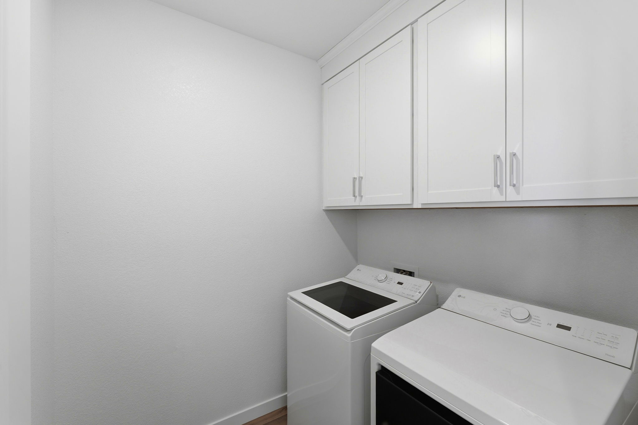 A white kitchen with white cabinets.
