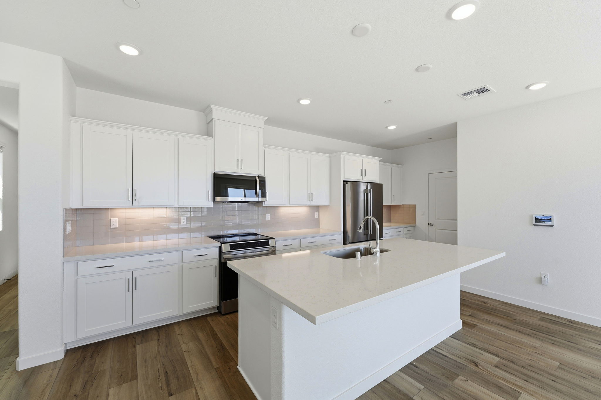 A kitchen with white cabinets.