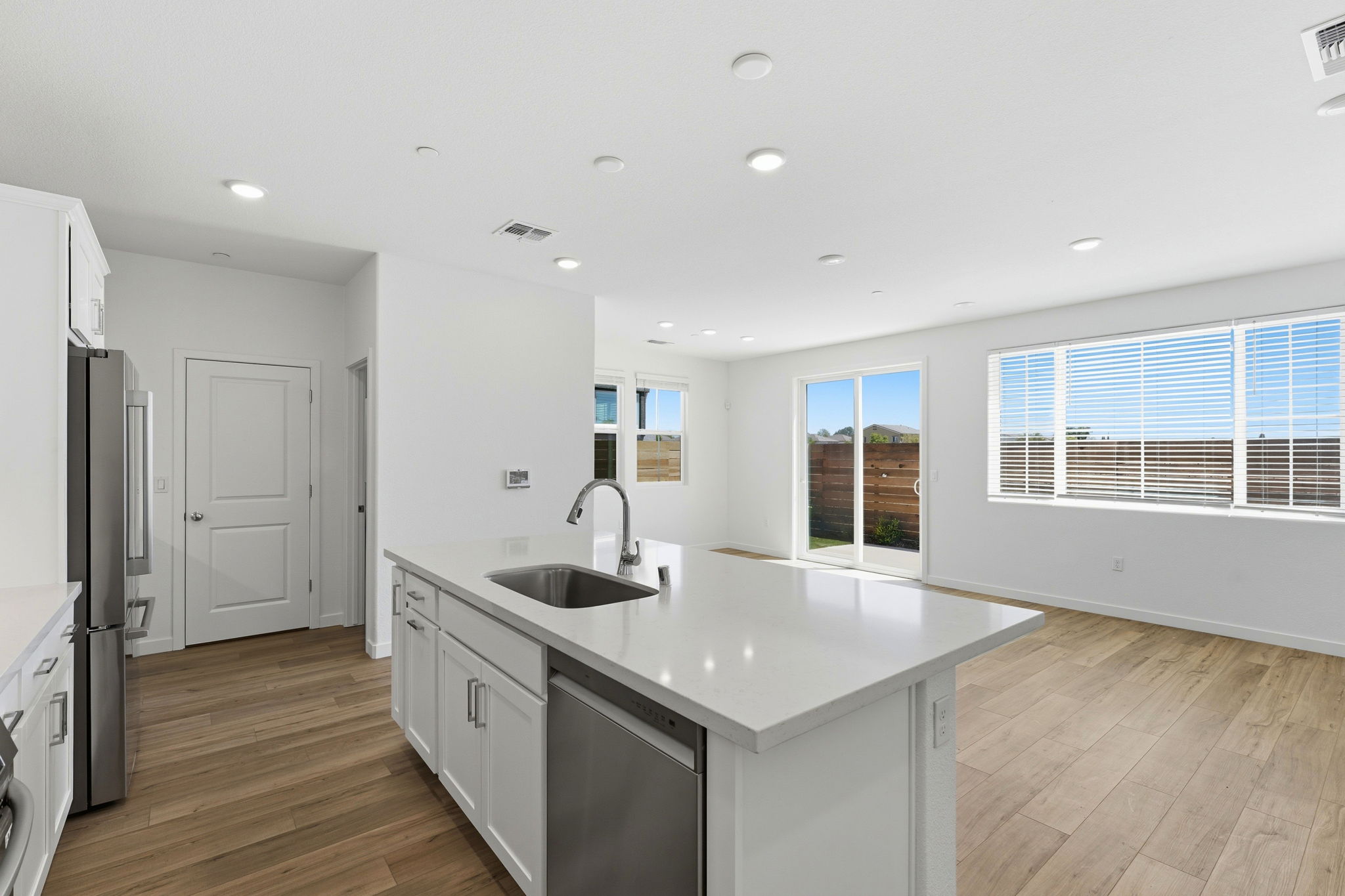 A kitchen with white cabinets.