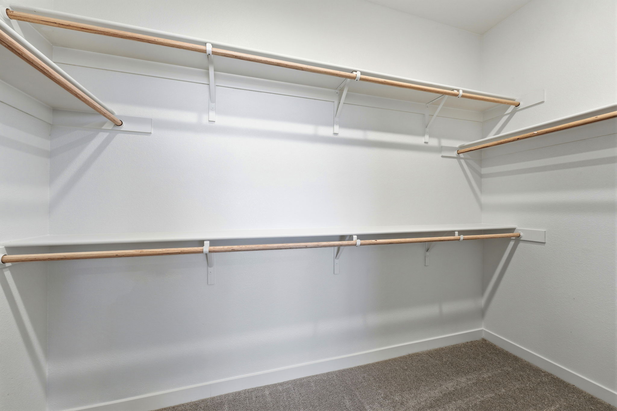 A white wall with a metal bar.