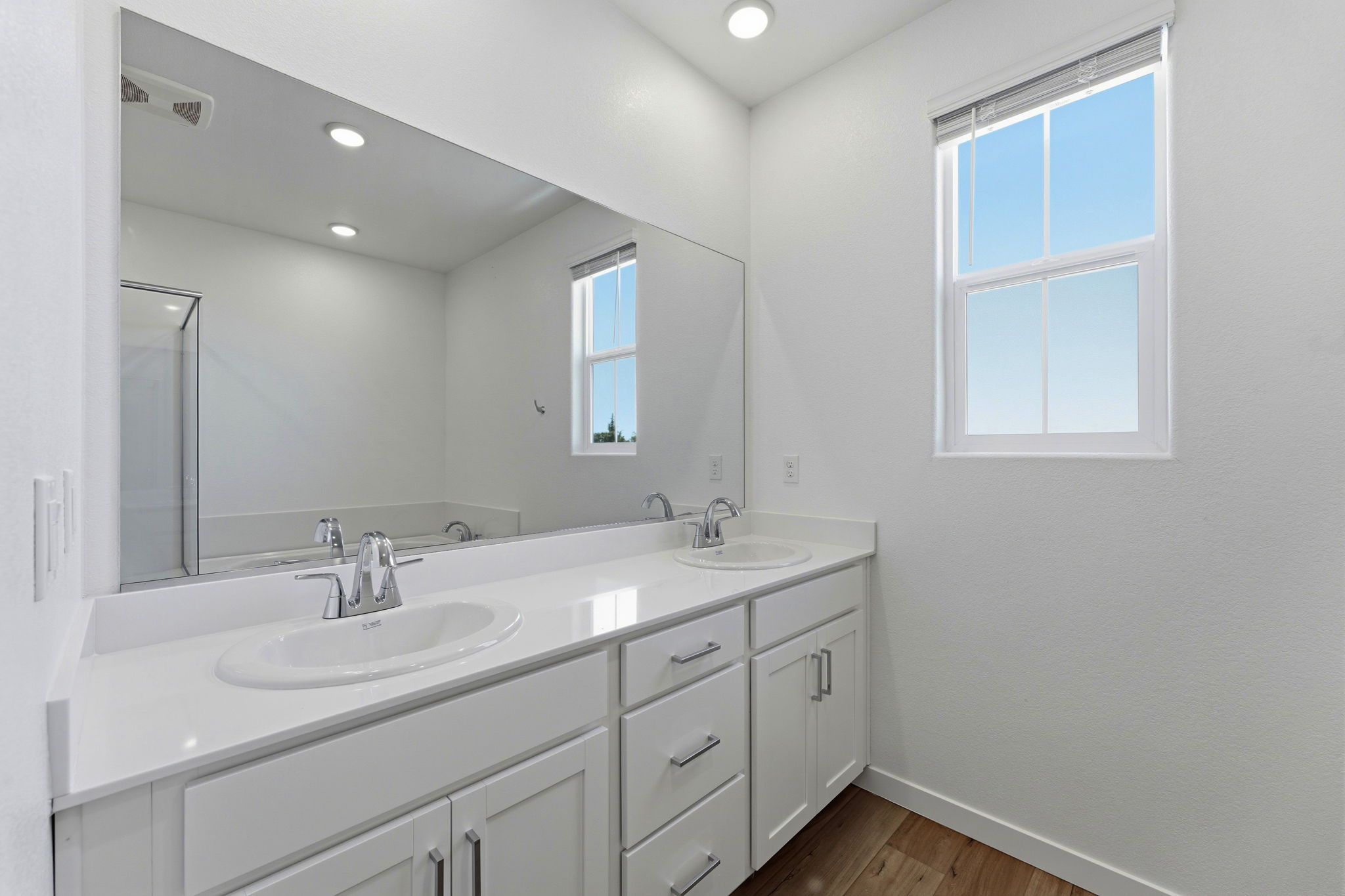A bathroom with a large mirror.