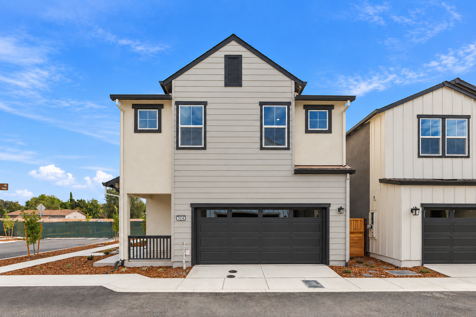A white house with a garage.