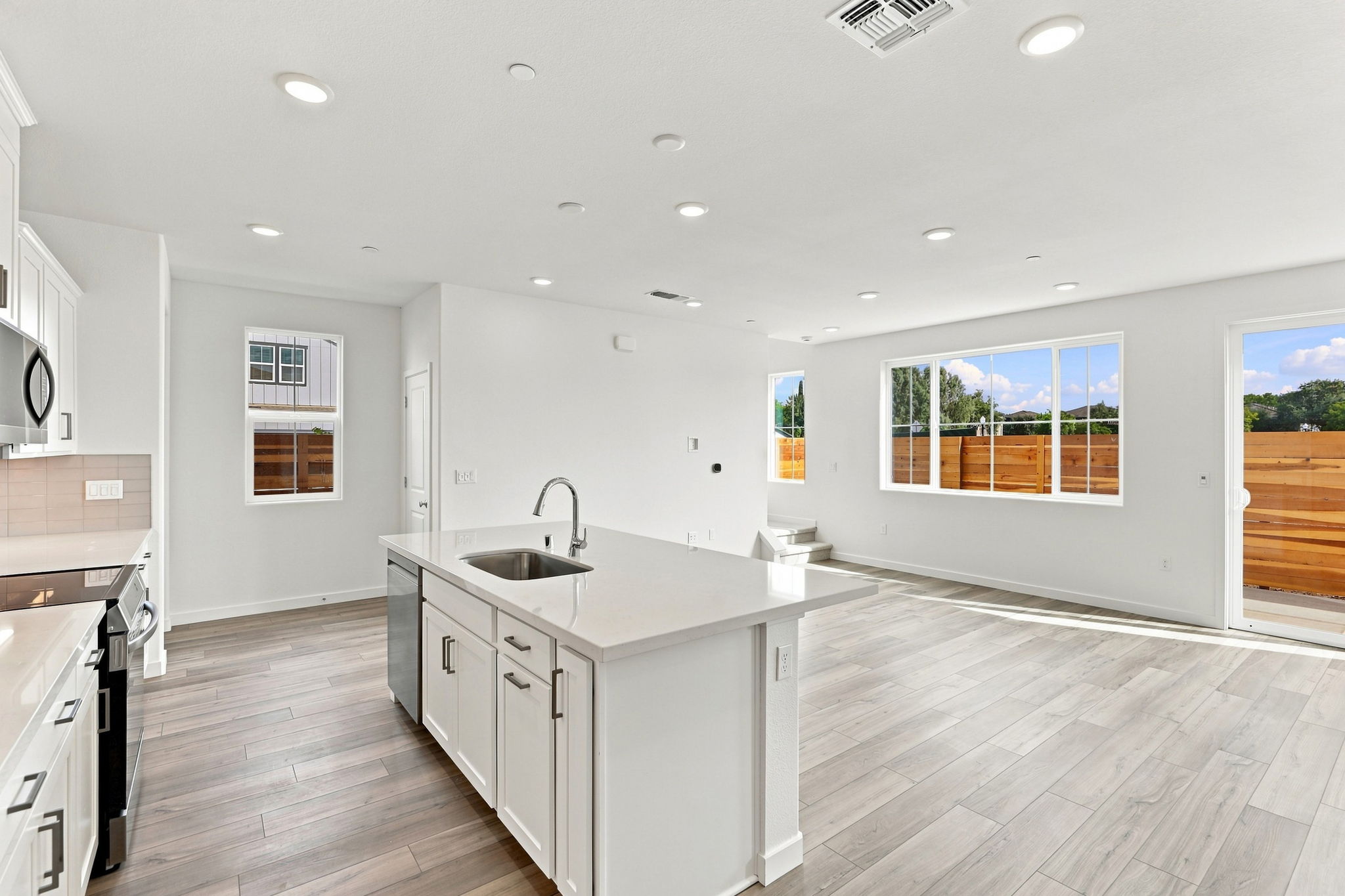 A kitchen with white cabinets.