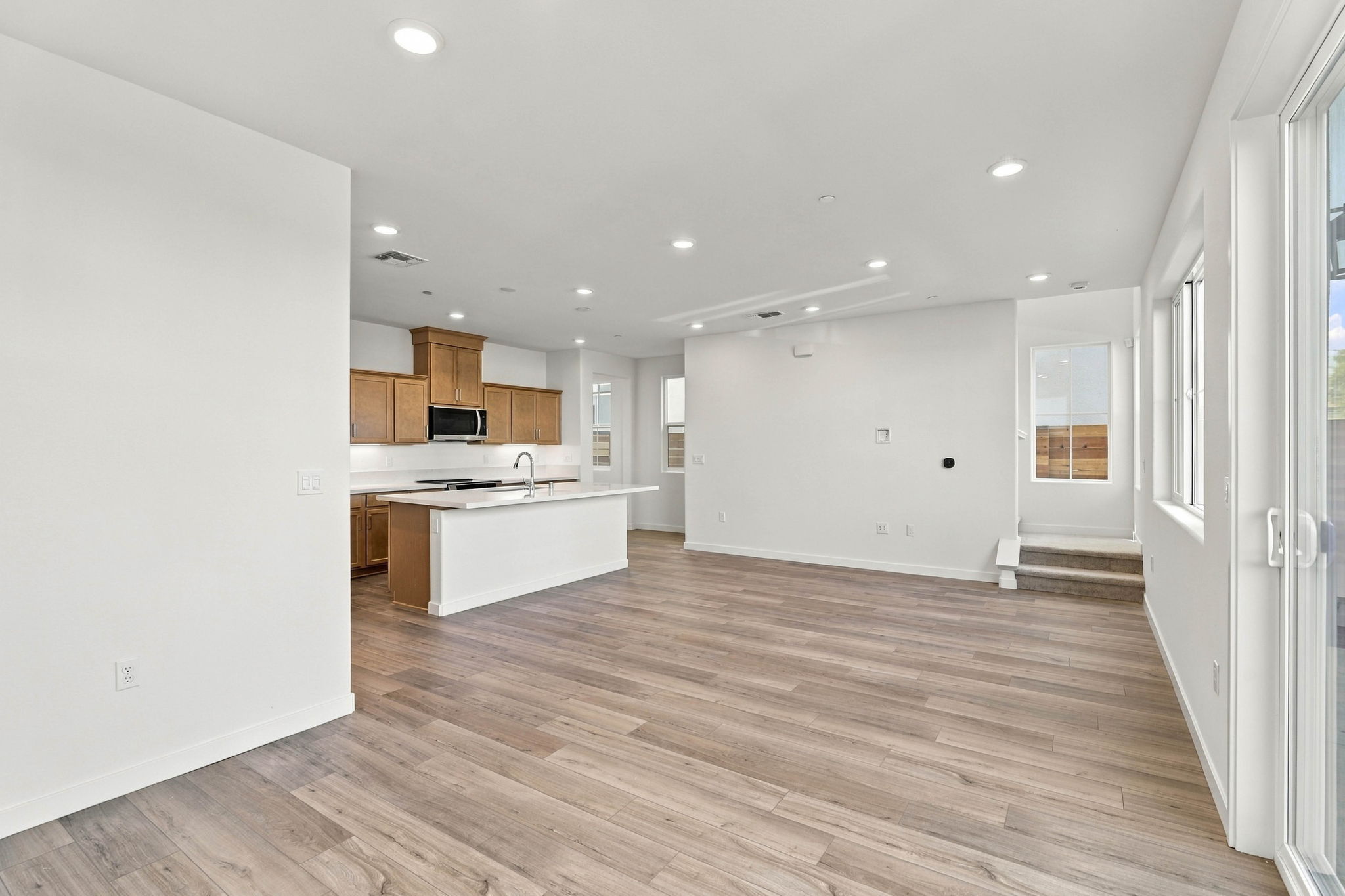 A large kitchen with wooden floors.