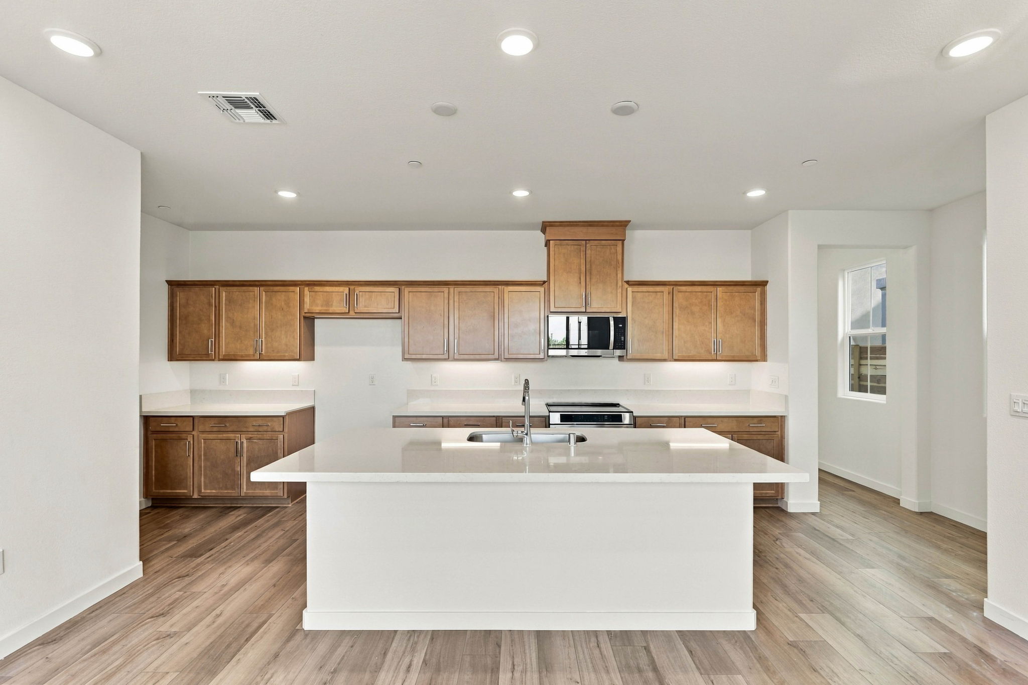 A kitchen with wooden cabinets.