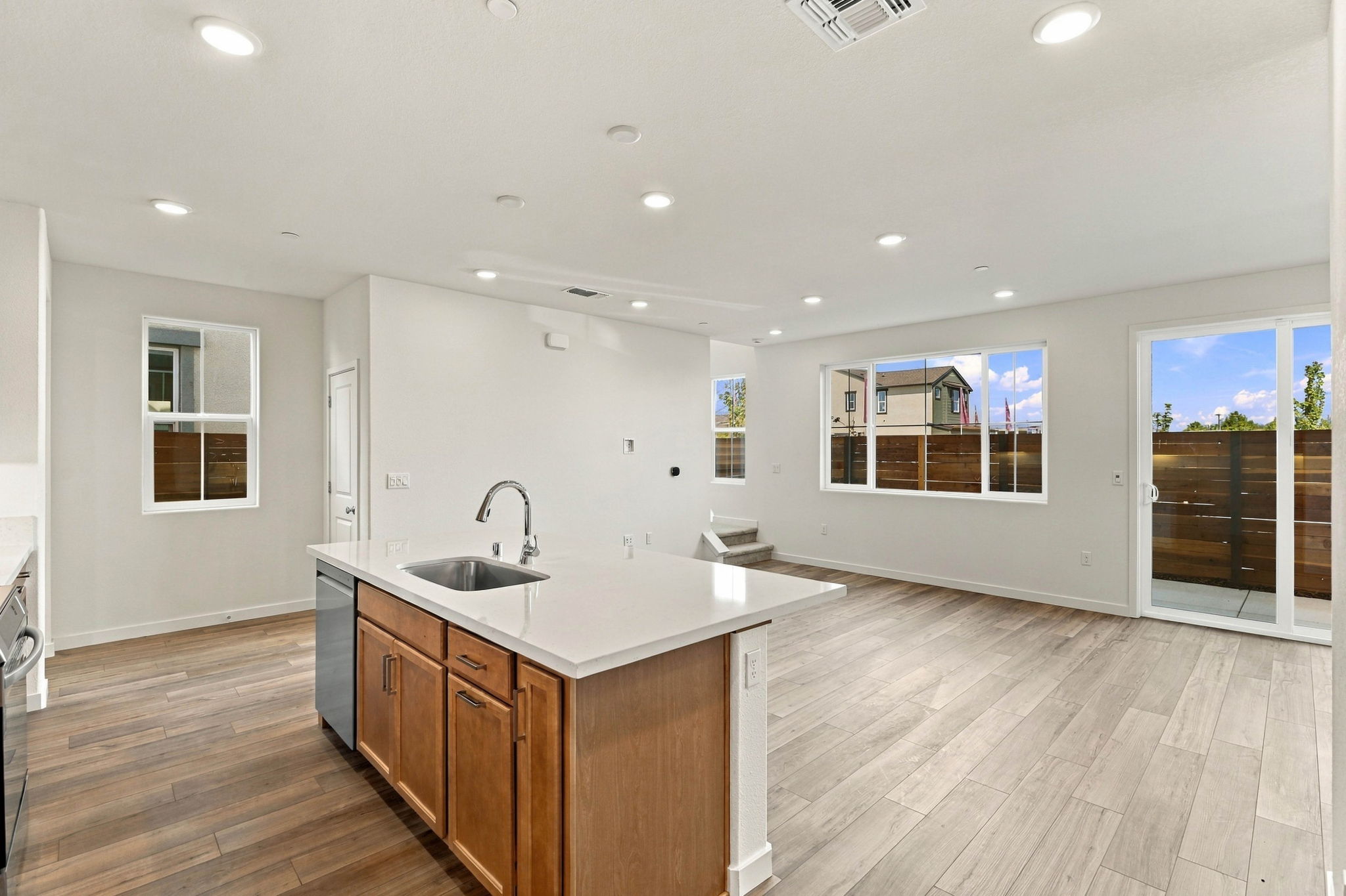 A kitchen with a wood floor.
