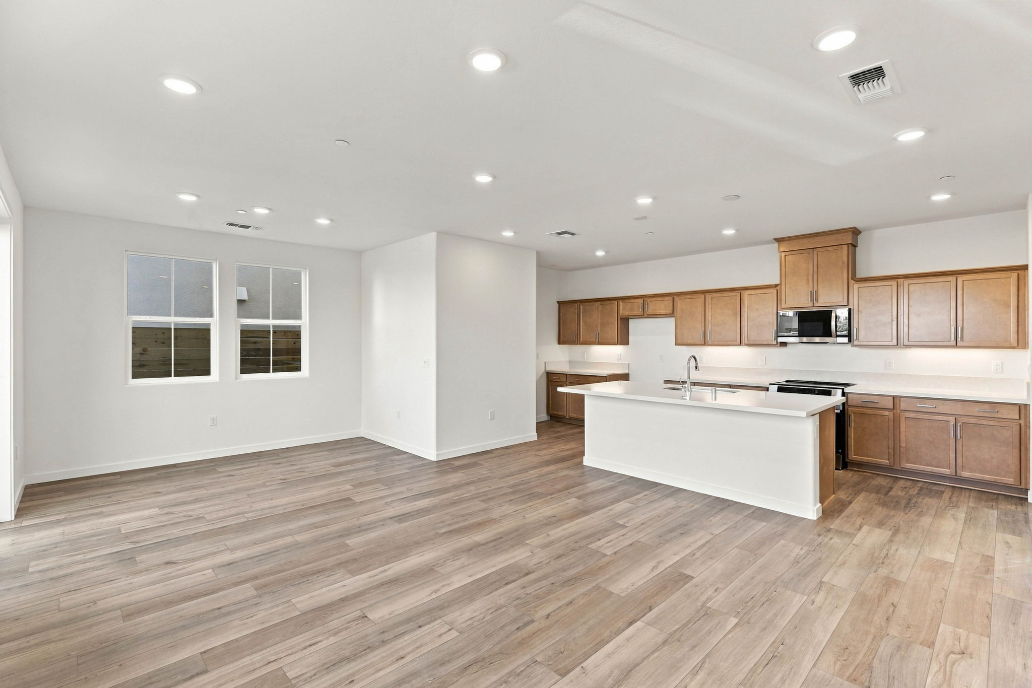 A large kitchen with wooden floors.