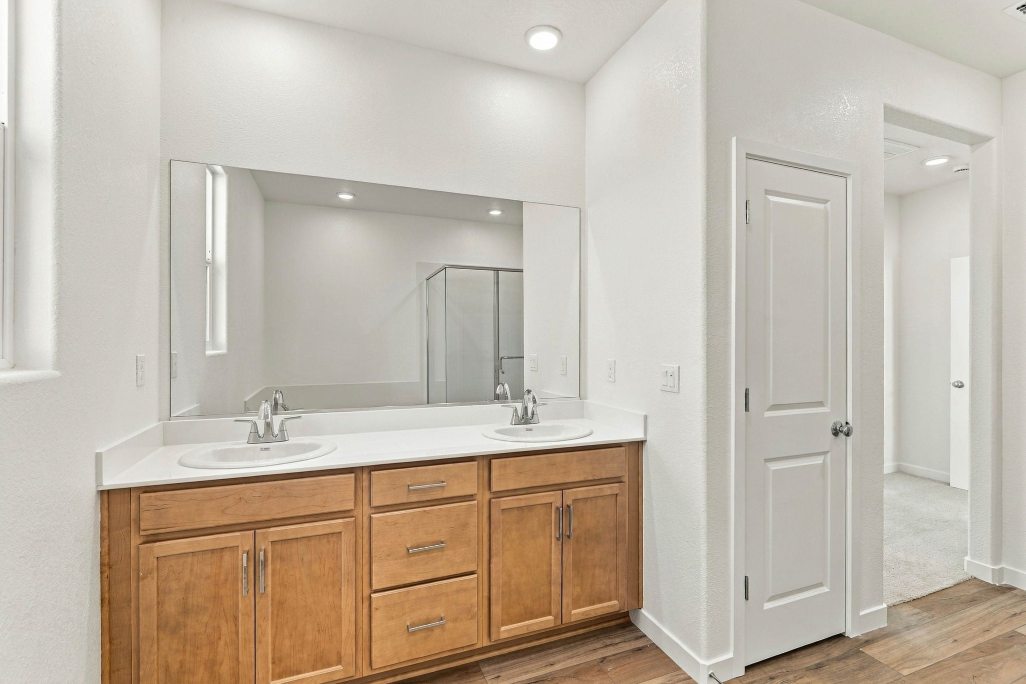 A bathroom with a large mirror.