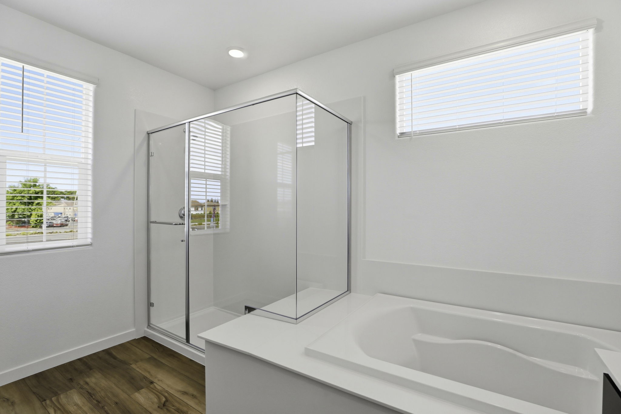 A white bathroom with a glass shower.