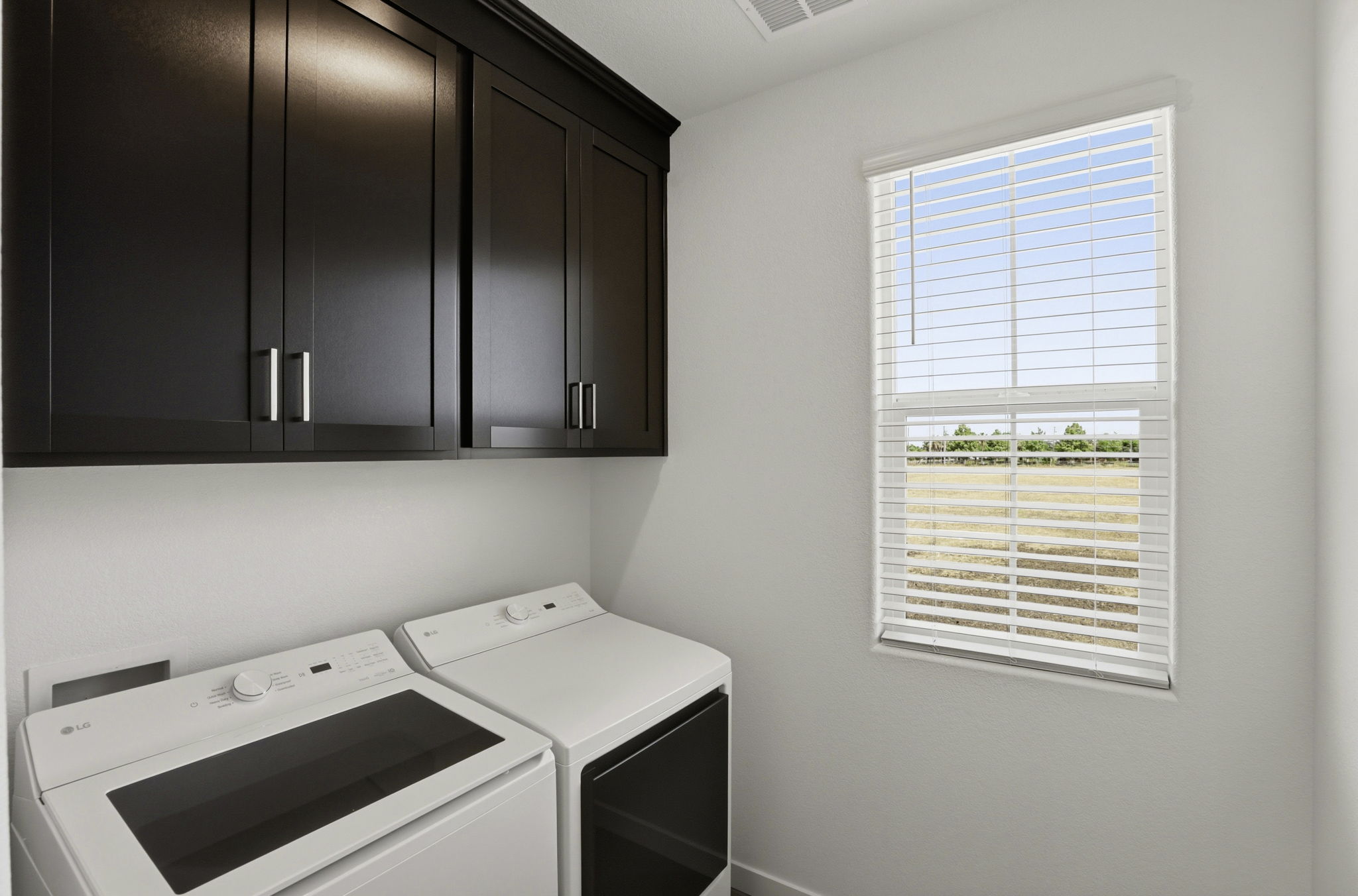 A kitchen with black cabinets.