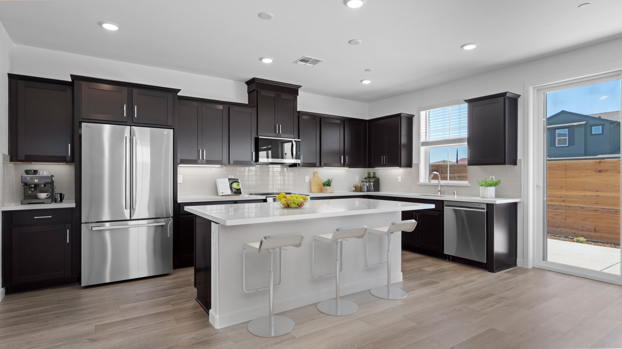 A kitchen with black cabinets.