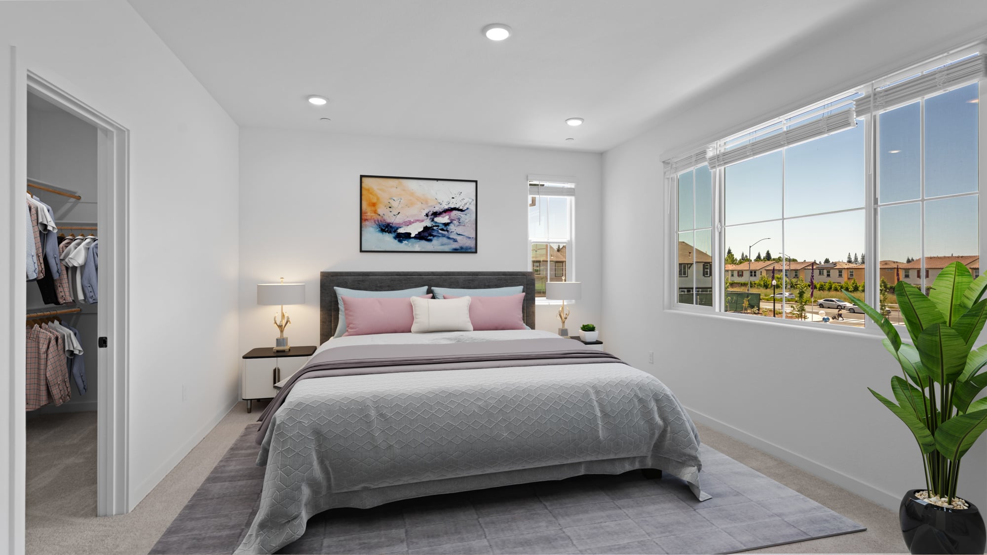 A bedroom with a large window.